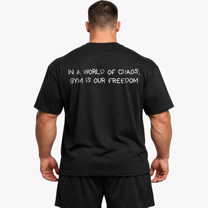 IN A WORLD OF CHAOS, GYM IS OUR FREEDOM Oversized (Backprint) Shirt